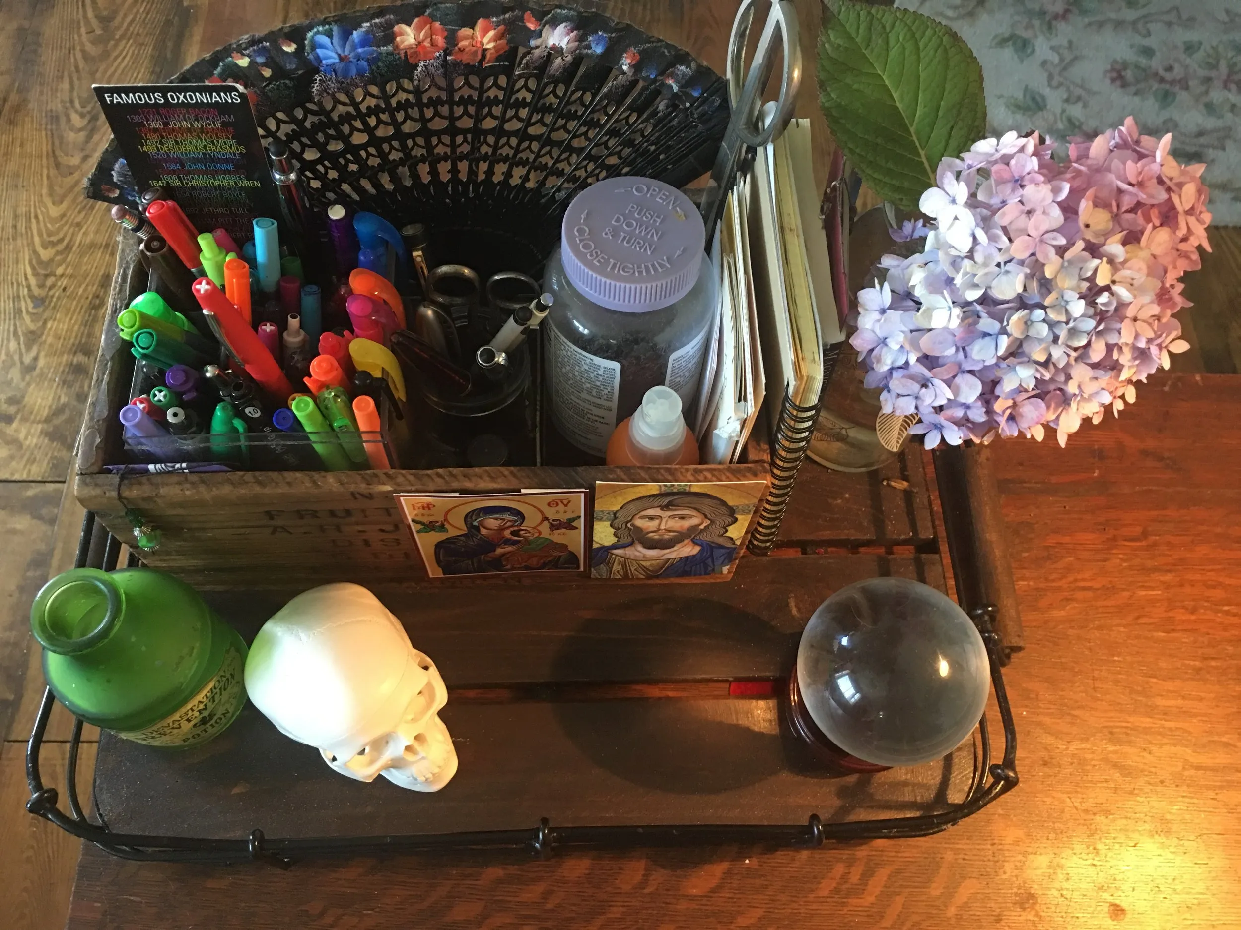 The tray that collects all my miscellaneous stuff. The skull is memento mori; the crystal ball tells me nothing about the future, but is useful to play with when I’m puzzling something out.